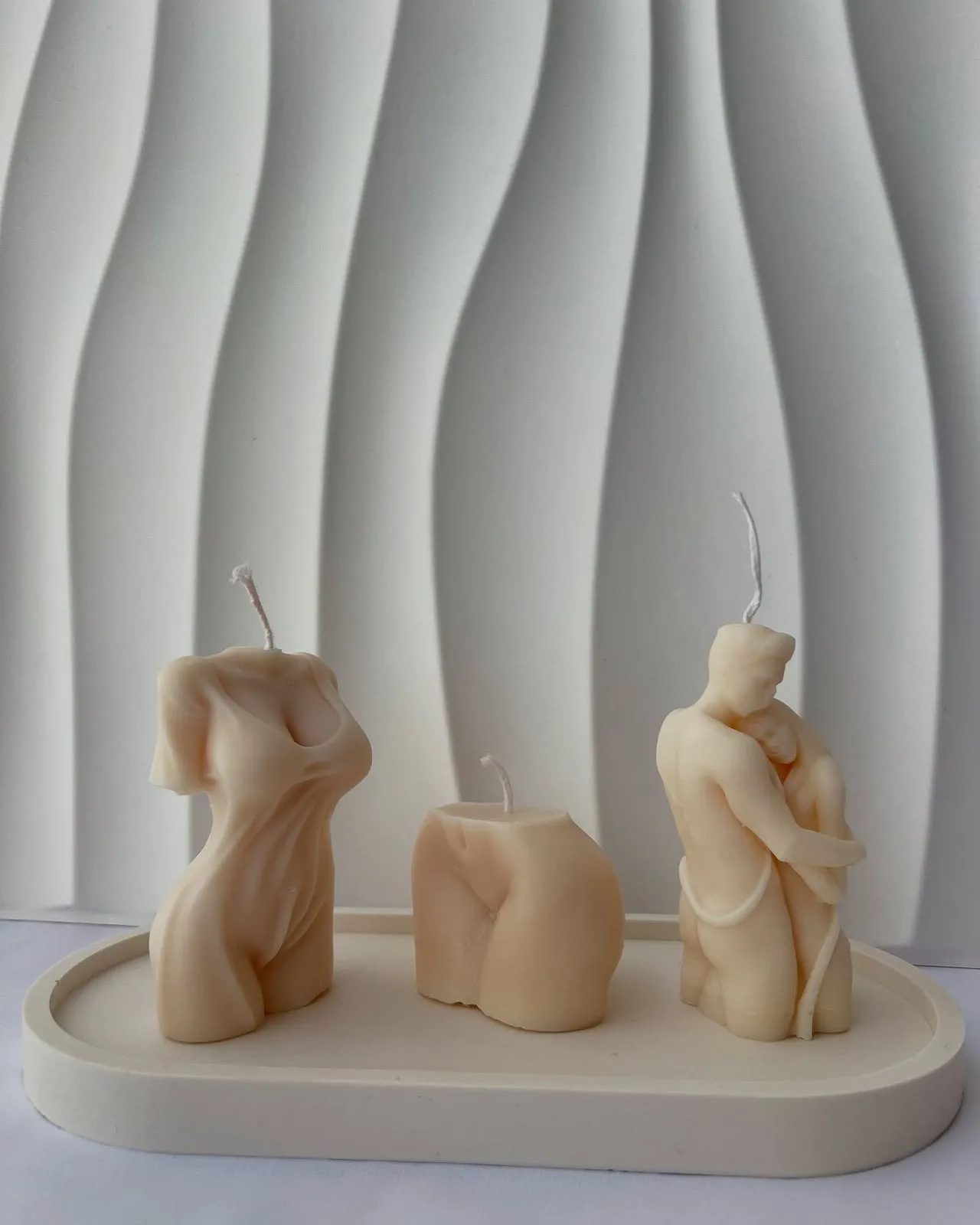 Sculptural figure candles on a tray