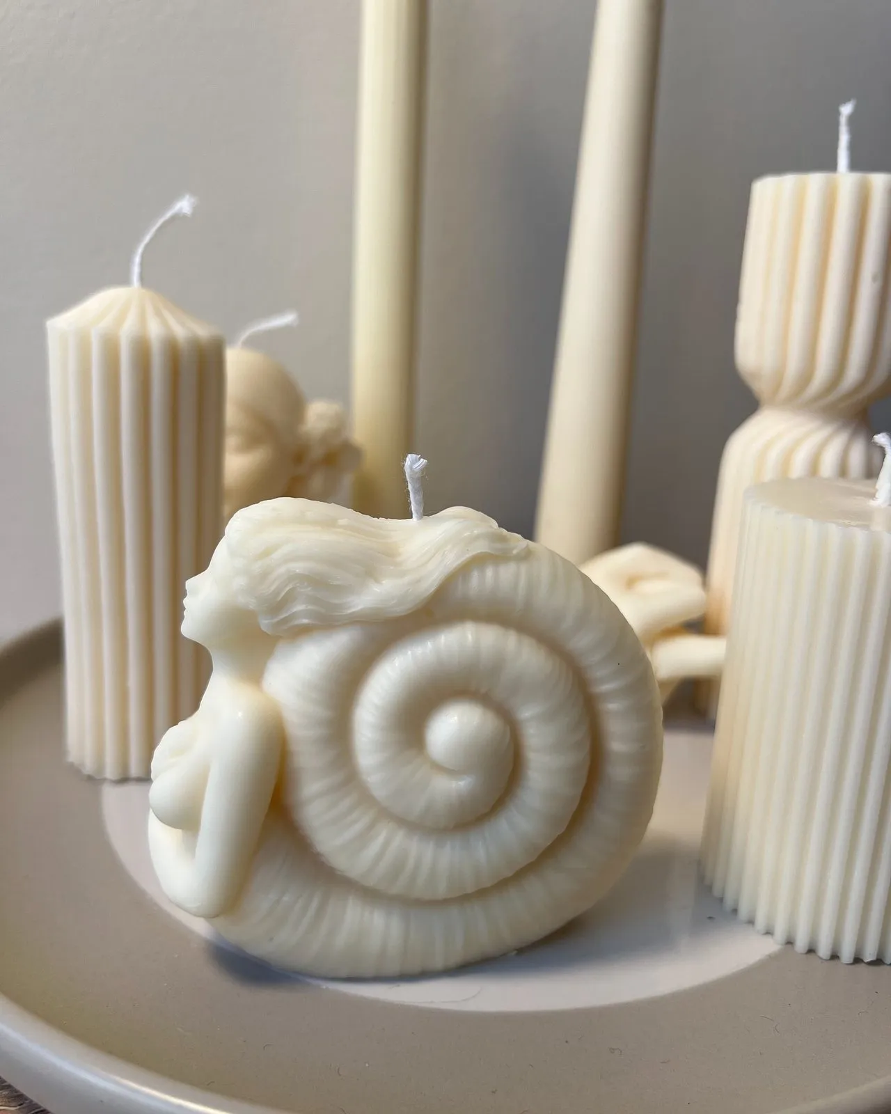 Snail candle and ribbed pillar on a jesmonite plate