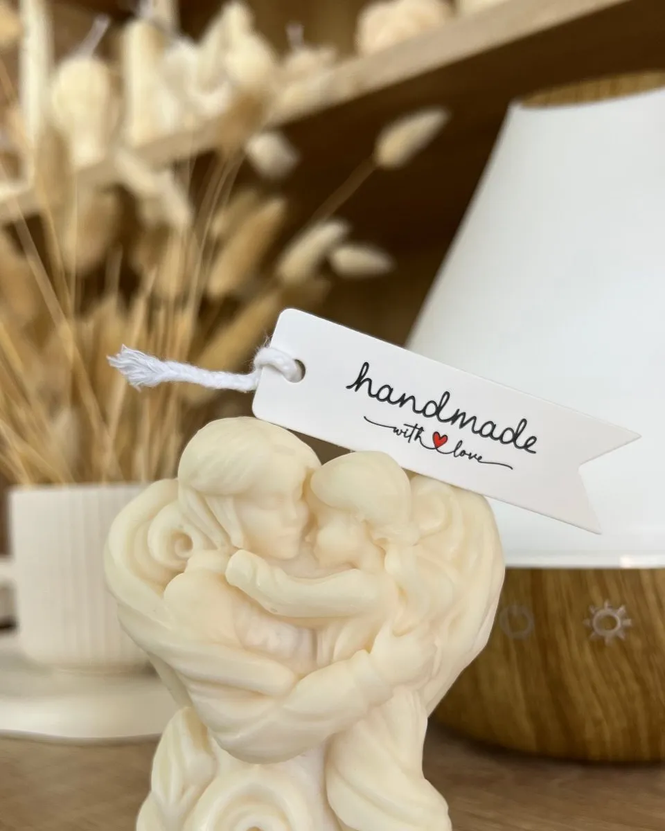 Sculptural mother-and-child candle with a “handmade” tag